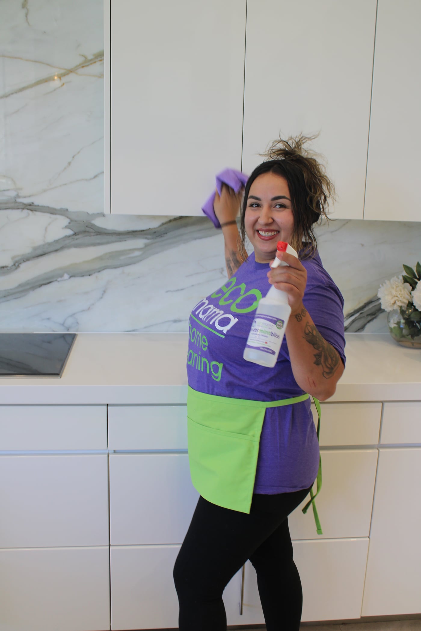 Eco Mama cleaner wiping a modern marble kitchen for a move-in clean